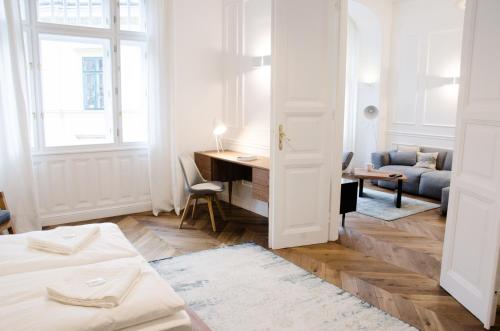 a white room with a bed and a desk at Luxury Apartment by Hi5 - Best Location 3-br in Budapest