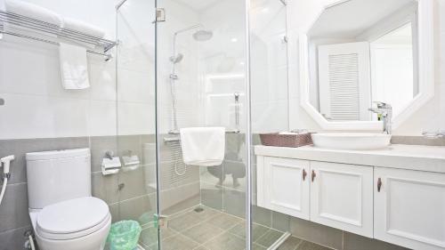 a bathroom with a toilet and a sink and a shower at Nguyen Du Paradise Hotel - Hoan Kiem Lake in Hanoi