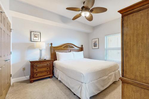 Un dormitorio con una cama y un ventilador de techo. en Sea Dunes 602, en Fort Walton Beach