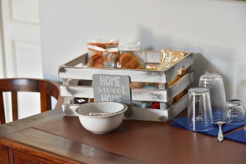 a wooden table with a bowl on top of it at Liberty House in Turbigo
