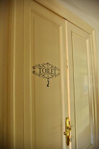 a door with a sign that reads toilet access at Liberty House in Turbigo