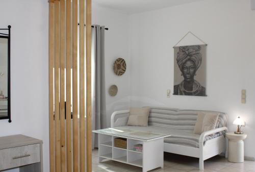 a living room with a couch and a table at Fissas Rooms in Sivota