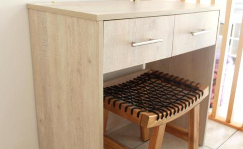 a wooden cabinet with a stool under it at Fissas Rooms in Sivota