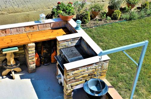 a outdoor pizza oven in a yard at Unicum Vendégház in Abádszalók
