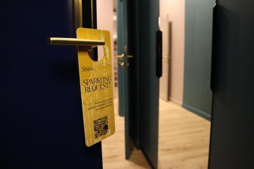 a yellow door with a sign on it at Aparthotel Amella in Rīga