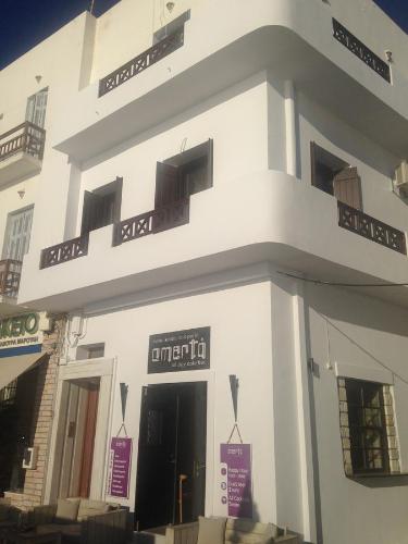 a white building with signs on the front of it at Amalthia Luxury Studios in Naxos Chora