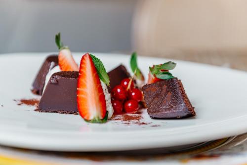 a plate of chocolate desserts with strawberries on it at Hotel Due Palme in Mergozzo