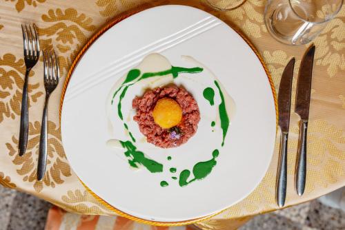 a plate with an egg on a table at Hotel Due Palme in Mergozzo