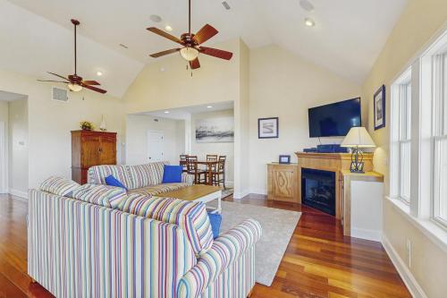 a living room with two couches and a ceiling fan at 2BNWaves #2-W in Waves