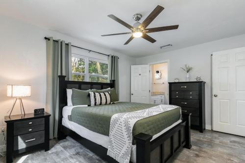 a bedroom with a bed and a ceiling fan at Modern & Tasteful Pool Home in Gainesville