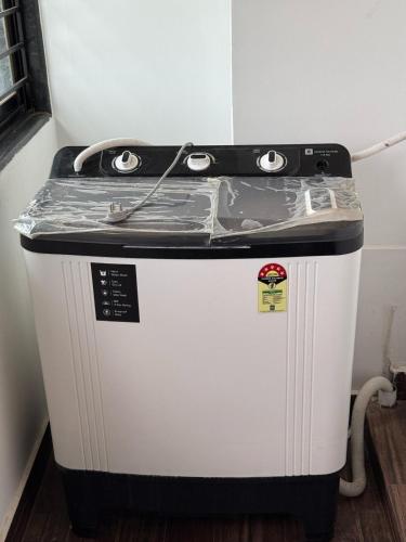a small refrigerator with a counter on top of it at Hope in Udupi