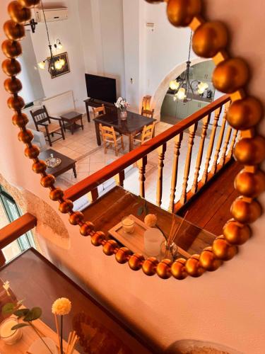 a spiral staircase with a living room and a dining room at Skandalis Apartments with pool in Chorafakia