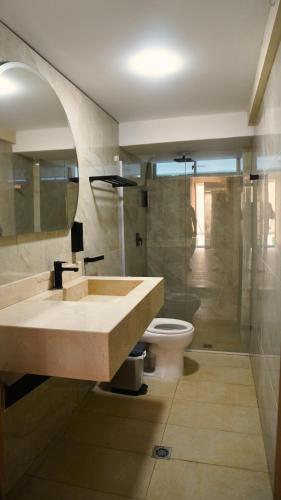 a bathroom with a sink and a toilet at Hotel y Cabañas Covemar in Coveñas