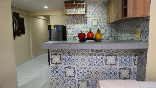a kitchen with a counter with fruit on it at Hotel y Cabañas Covemar in Coveñas