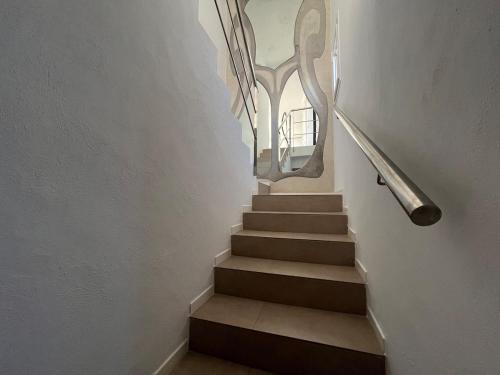 a stairway with a railing and a stair case at Villa Rosita Ibiza in Talamanca