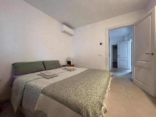 a bedroom with a large bed in a room at Villa Rosita Ibiza in Talamanca