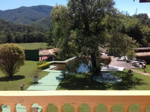 a view from the balcony of a house with a tree at Hotel Fazenda Pedra Selada Rural in Visconde De Maua