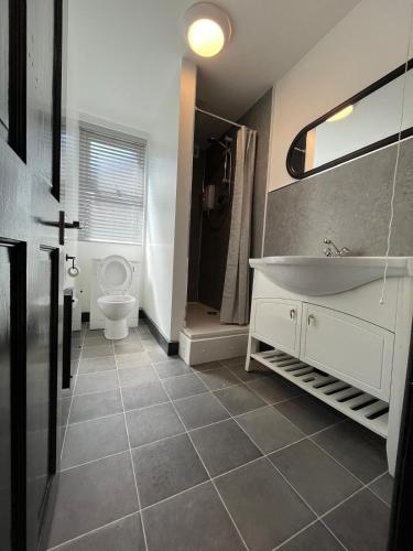 a bathroom with a white tub and a toilet at 80 Anfield house in Liverpool