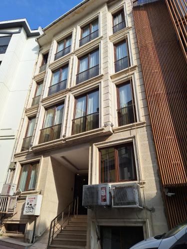 a building with windows and stairs in front of it at Galata King Suites in Istanbul