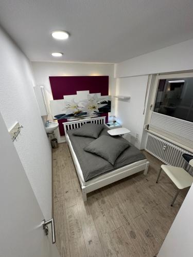 a small bedroom with a bed and a window at My Home Hostel Deluxe Lüdinghausen in Lüdinghausen