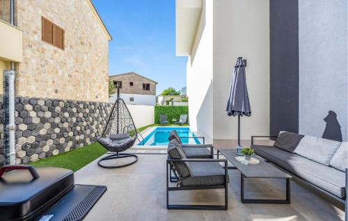 a patio with a couch and chairs and a swing at Beautiful Apartment In Jezera With Wifi in Jezera