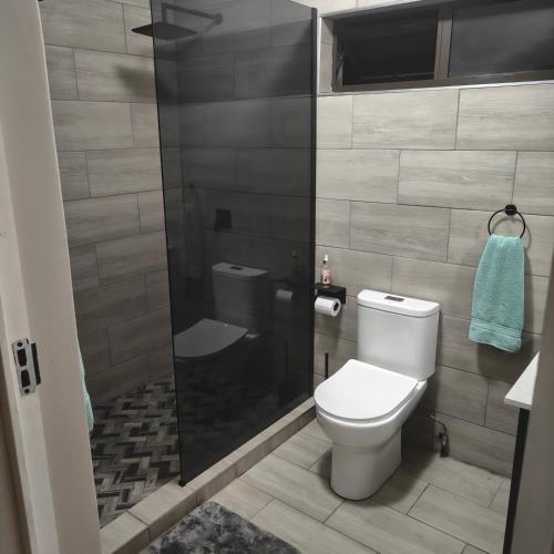 a bathroom with a toilet and a shower at 52 on Marlynhoek Self Catering Apartment in Richards Bay