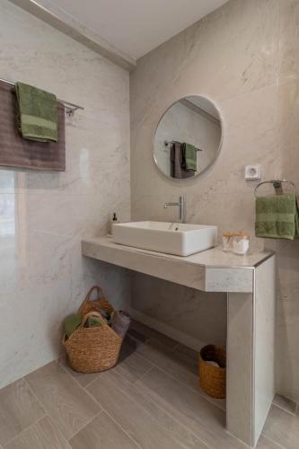 a bathroom with a sink and a mirror at Onda Blu in Rhodes Town