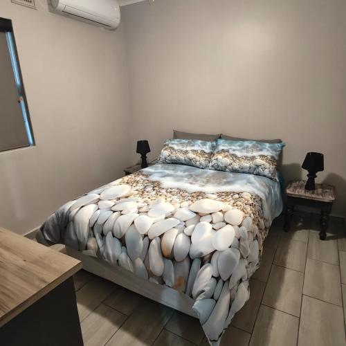 a bedroom with a bed and two night stands at 52 on Marlynhoek Self Catering Apartment in Richards Bay