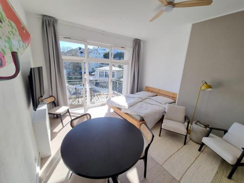 a living room with a table and a window at Apartment mit Meerblick und Südbalkon in Sassnitz