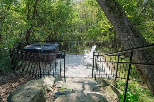 a gate with a hot tub and a tree at Bromont Lodge 837 shefford suite 200 in Bromont