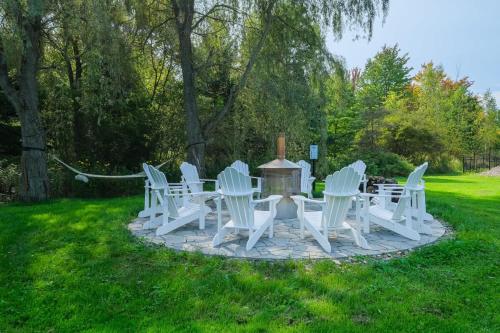 a group of white chairs and a table in the grass at Bromont Lodge 837 shefford suite 200 in Bromont
