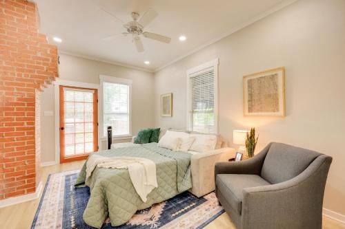 un dormitorio con una cama y una silla en San Antonio Home 2 Mi to Dtwn, Swim Spa!, en San Antonio