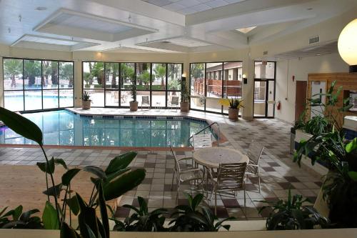 a swimming pool with a table and chairs in a building at Marriott El Paso in El Paso