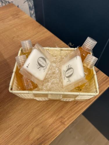 a table with two bottles of honey on it at AZ rooms in Noto