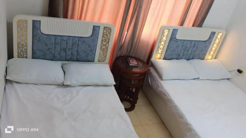 two beds sitting next to each other in a room at Elsokhna BlueBay Asia For families only in Ain Sokhna