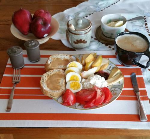 a plate of food with eggs and fruit on a table at Our Valley View Bed & Breakfast in Hampton