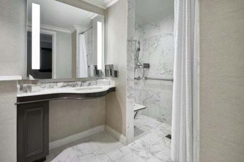 a bathroom with a sink and a mirror and a shower at The Ritz-Carlton, Tysons Corner in Tysons Corner