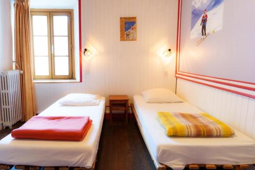 Postel nebo postele na pokoji v ubytování Auberge l'Estoilies