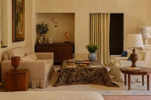 a living room with a couch and a table at Hôtel du Couvent, a Luxury Collection Hotel, Nice in Nice
