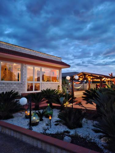 una casa con un jardín delante de ella por la noche en Villa Daisy Conversano-Polignano a Mare, en Conversano