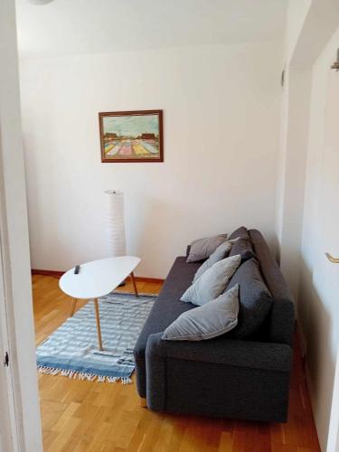 a living room with a couch and a table at First Floor Apartment 57A Fazekas utca in Tata