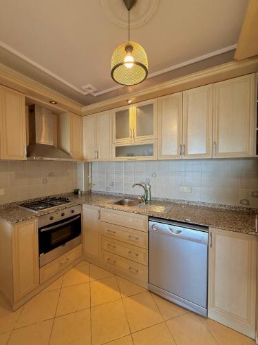 a kitchen with white cabinets and a sink at SA Apartments! Family 2BD Flat 150m to the Beach in Alanya