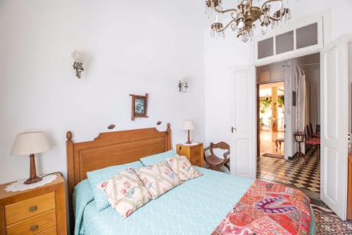 a bedroom with a bed with a blue comforter at Casa El Balcón de La Punta in Hermigua