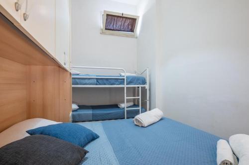 a small room with two bunk beds in it at Pierino Home 2 steps from the sea in Marina di Pisa