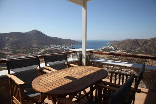 a table and chairs on a balcony with a view of the ocean at Skopelitis Village in Katapola