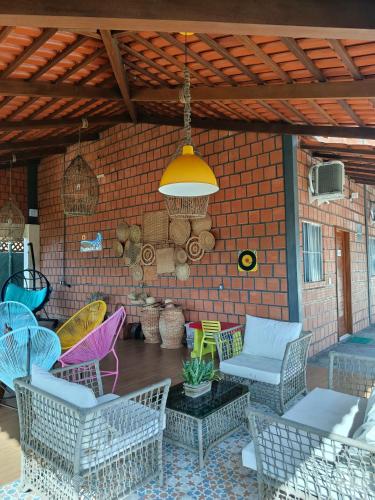 a patio with chairs and a table and a ceiling at POUSADA DOS LAGOS in Paulino Neves