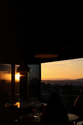 a dining room with a view of the sunset at Garenne in Livron-sur-Drôme