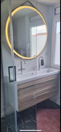 a bathroom with a sink and a mirror at Garden, Jacuzzi, bbq, city centre, 2 bedrooms in Alkmaar