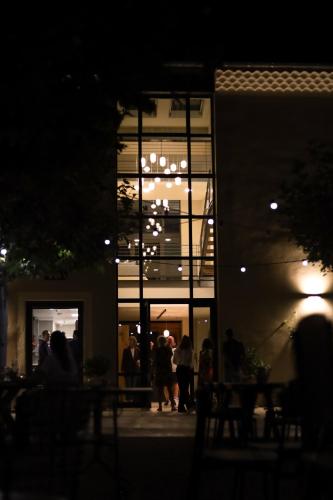 a group of people standing outside of a building at night at Garenne in Livron-sur-Drôme