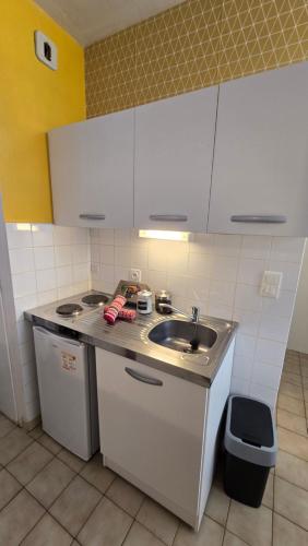 a kitchen with a sink and a counter top at Charme de Loire in Blois